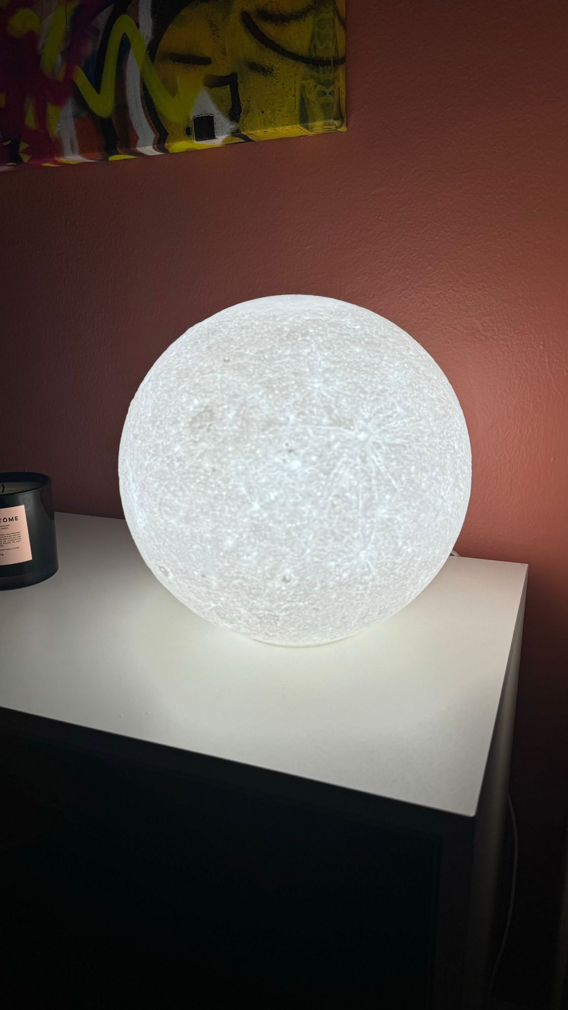 Moon night light turned on, glowing with adjustable brightness.